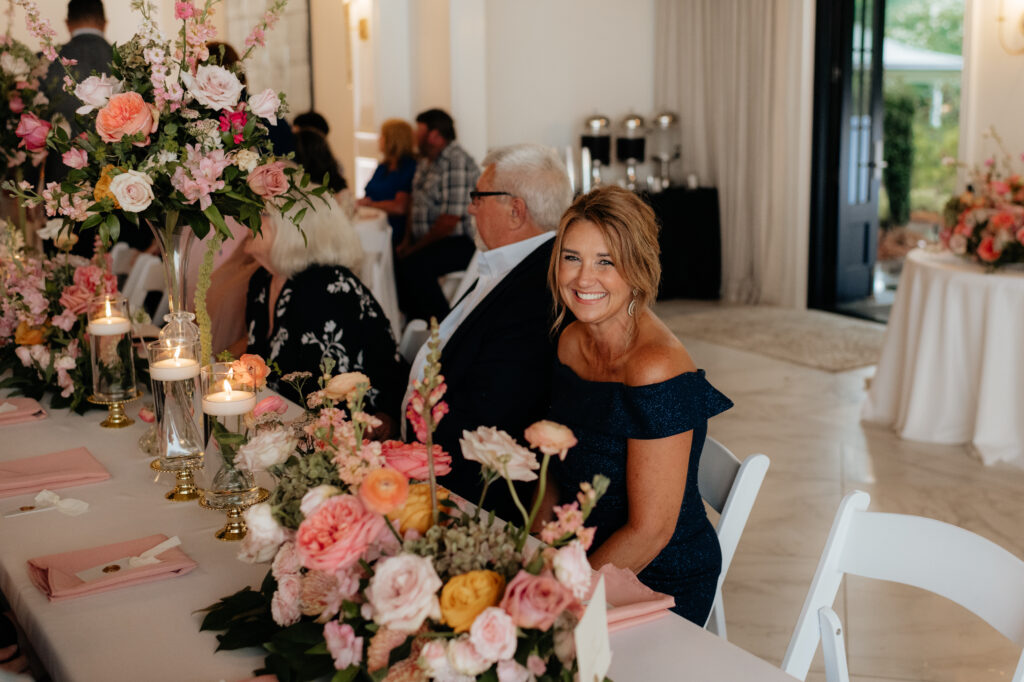 the mother of the bride seated at a table at a wedding in the lumpkin house, a wedding venue near gadsden, alabama