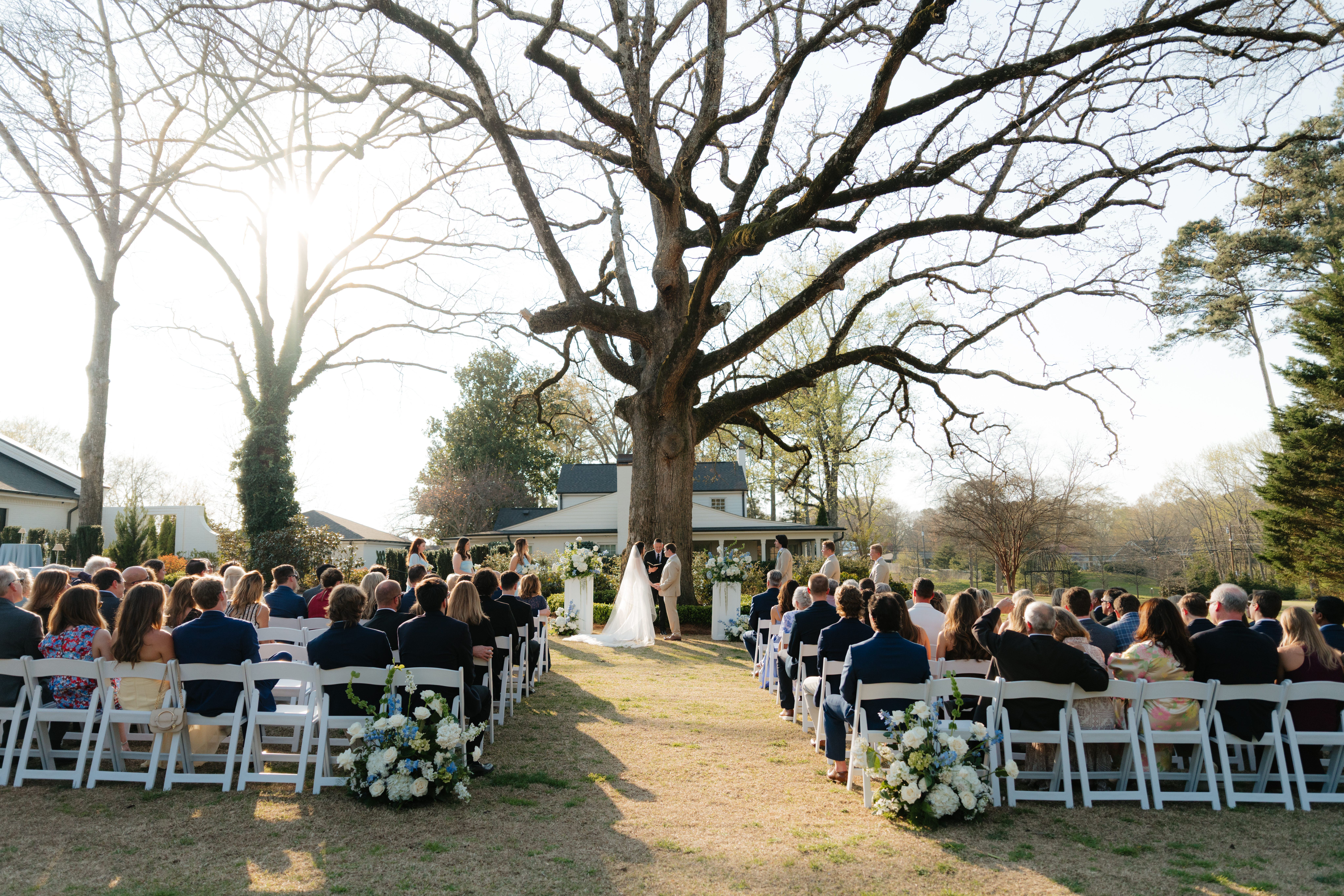an early march wedding ceremony at the live oak in the backyard of the lumpkin house wedding venue, albertville, alabama