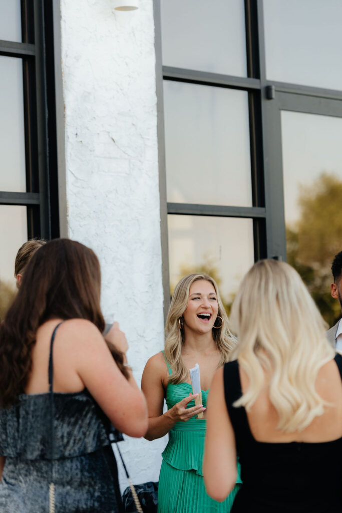 wedding guests chat and laugh during cocktail hour at howe farms, a european inspired venue in chattnooga, tn