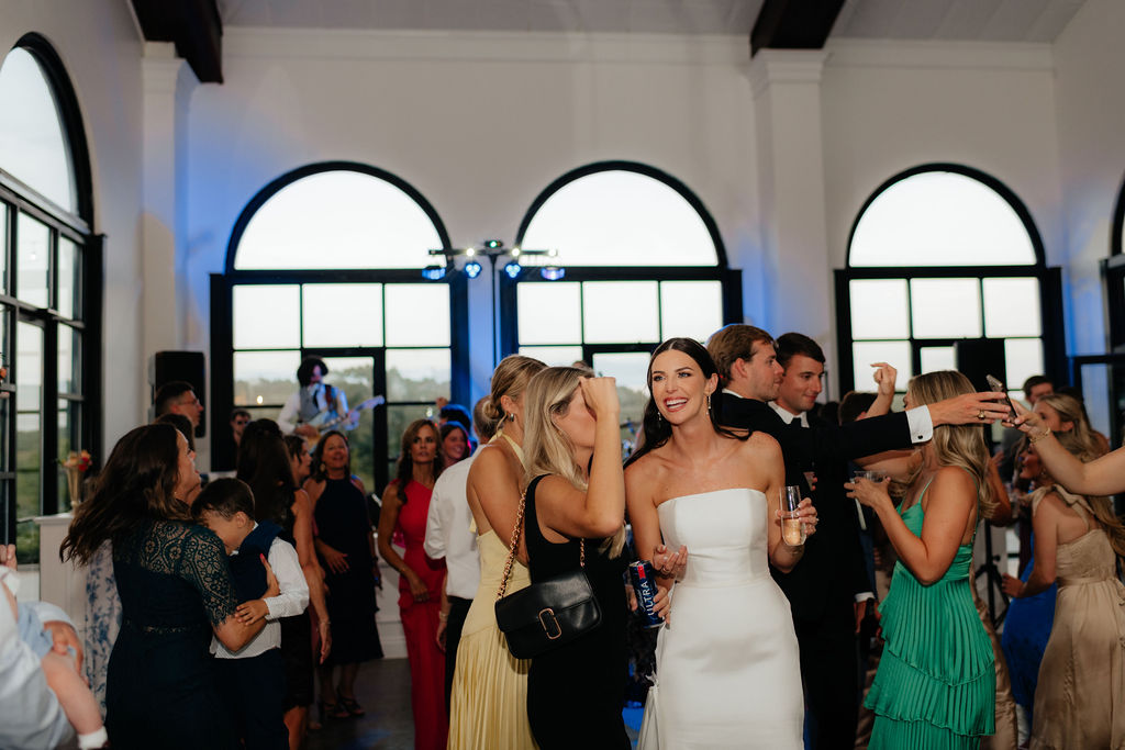 a bride chats with a guest during their wedding reception in chattanooga, tennessee at howe farms