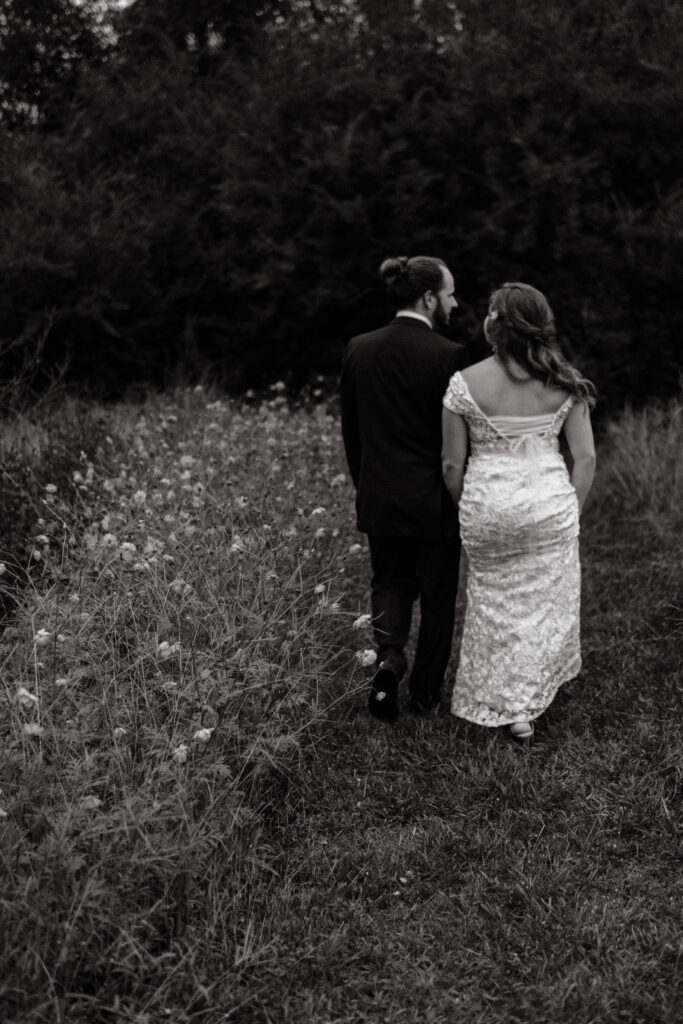 a couple walks together during their first look at the glasshouse alabama eden with alabama wedding photographer Sarah Mismash