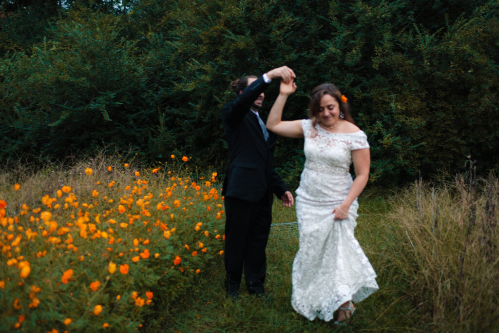a couple dances together during their first look at the glasshouse alabama eden with alabama wedding photographer Sarah Mismash