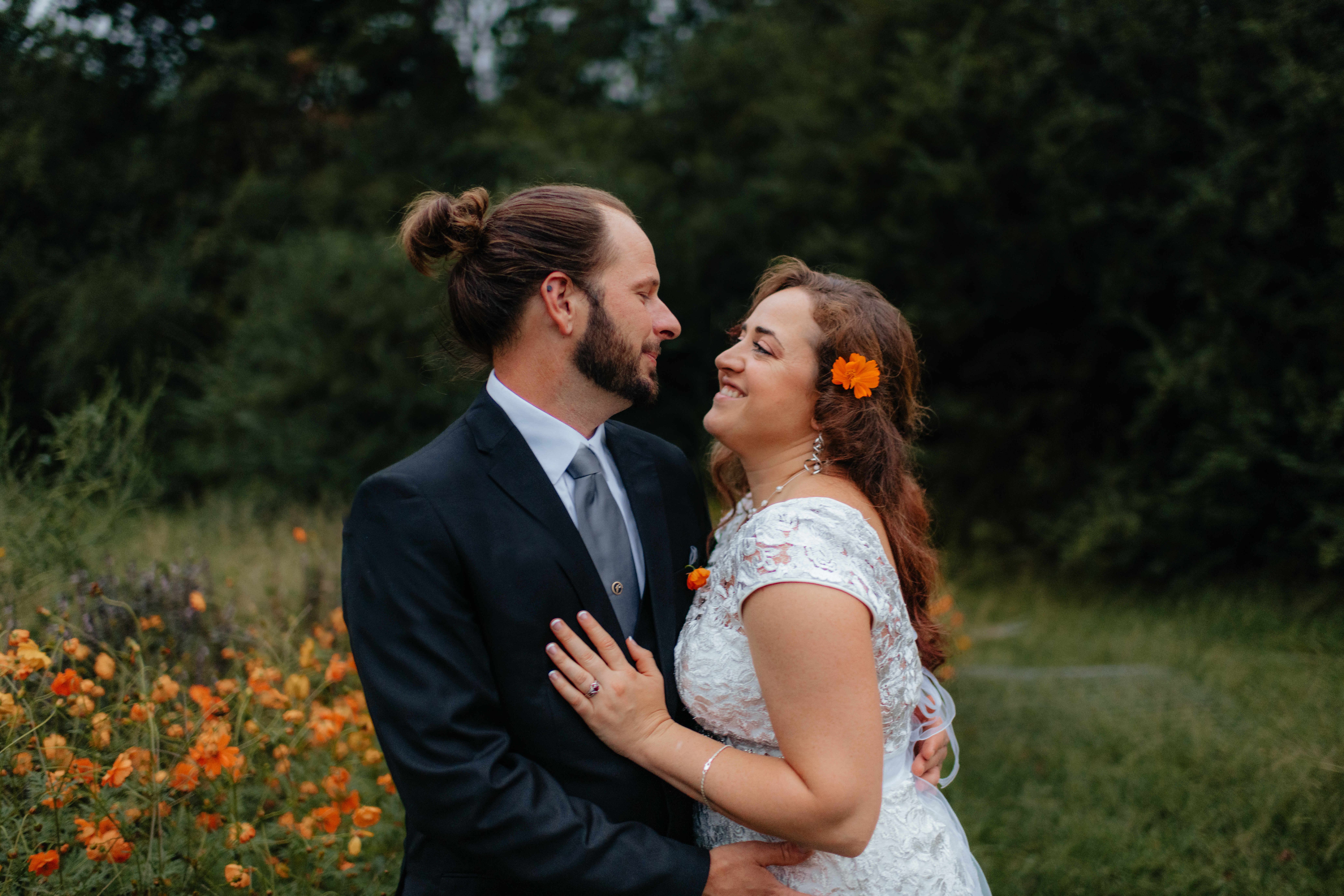 a couple holds each other during their first look at the glasshouse alabama eden with alabama wedding photographer Sarah Mismash