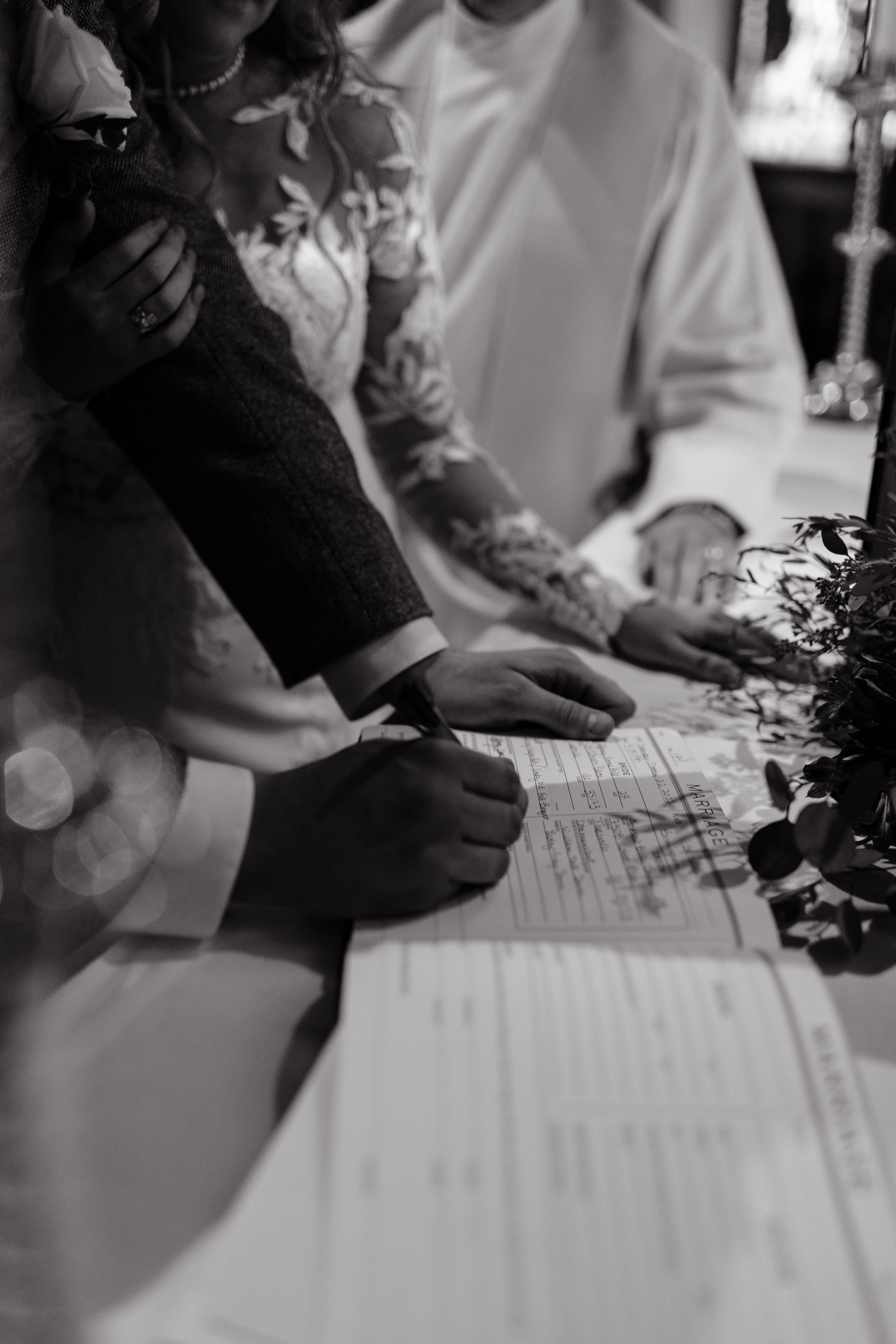 a bride and groom sign their marriage certificate after their wedding ceremony photographed by alabama wedding photographer Sarah Mismash
