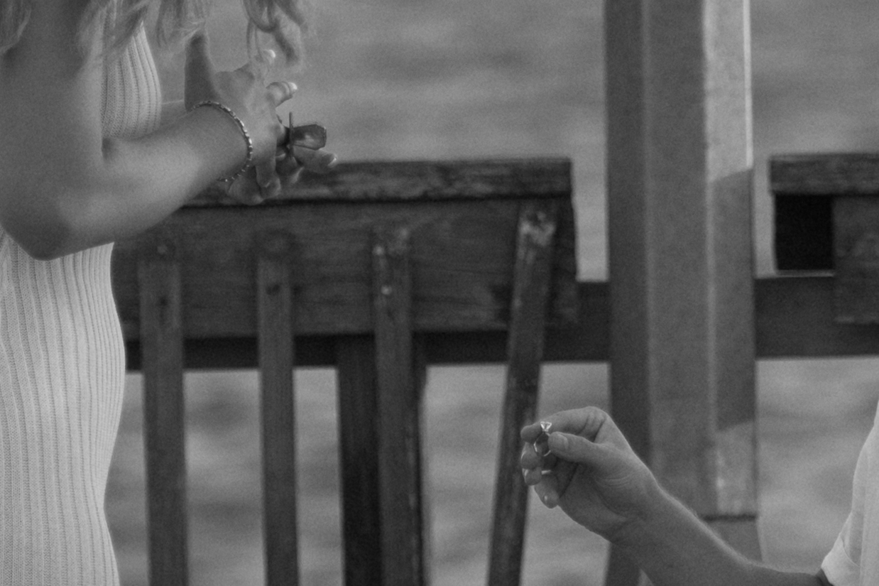 Man hands woman the ring on bended knee at Fairhope Municipal Pier, Alabama. Photos taken by Sarah Mismash Photography