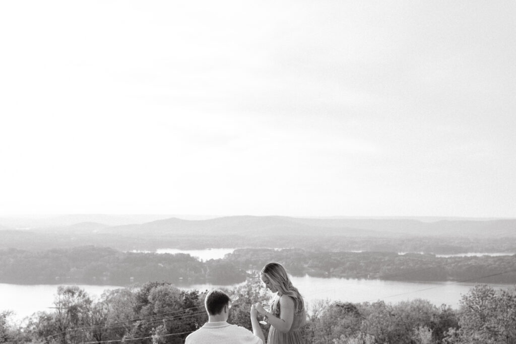 a couple sits down after their champagne pop in weathington park near guntersville, Alabama during their engagement photos with Sarah Mismash