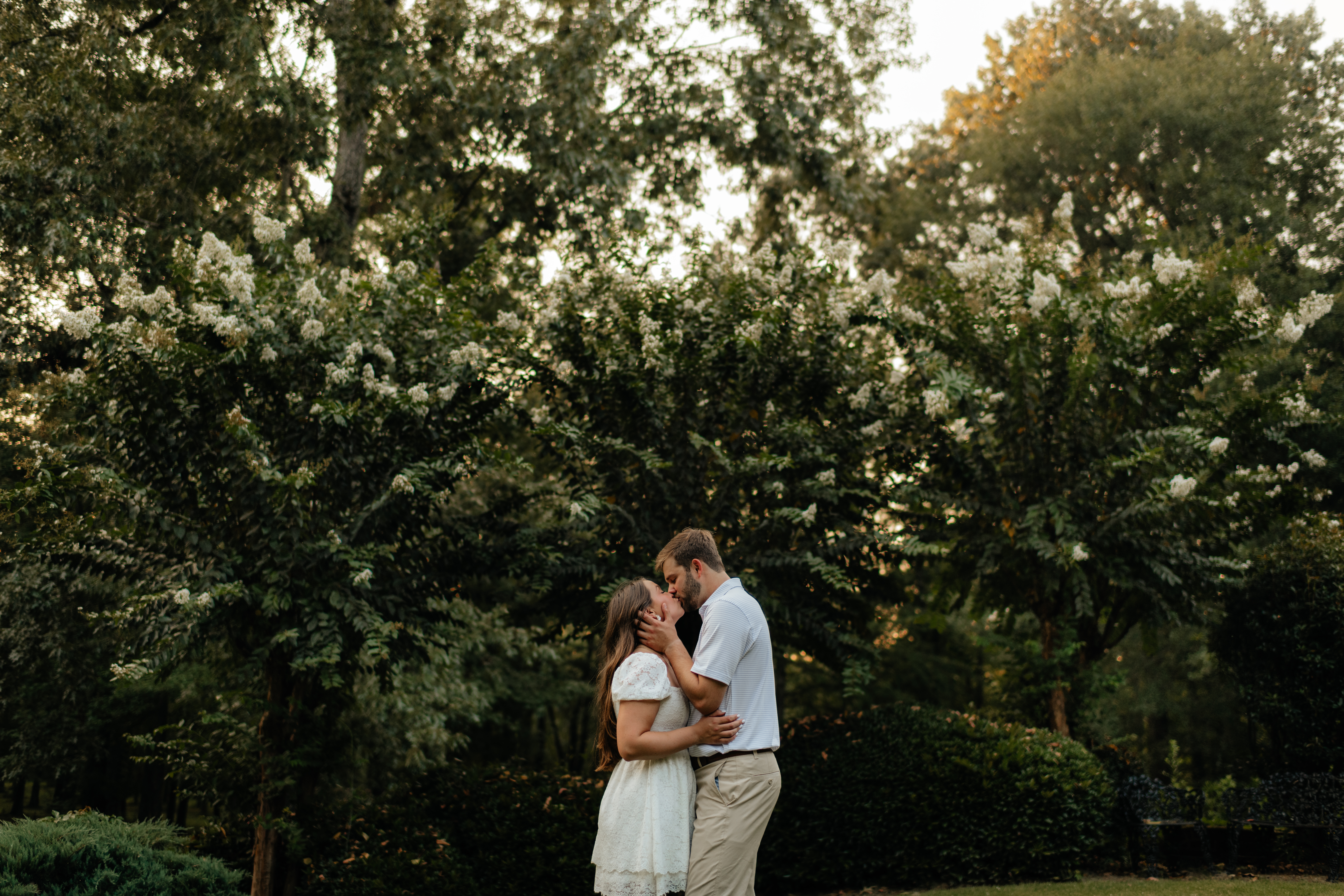 a couple kisses during their summer field engagement photos in calera, alabama, photography by Birmingham alabama wedding photographer Sarah Mismash