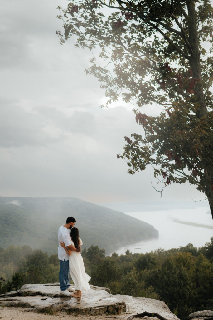 A couple weather the storm at their Engagement Photos, Weathington Park, Guntersville, Alabama. Photos produced and edited by Alabama and Washington Wedding Photographer Sarah Mismash