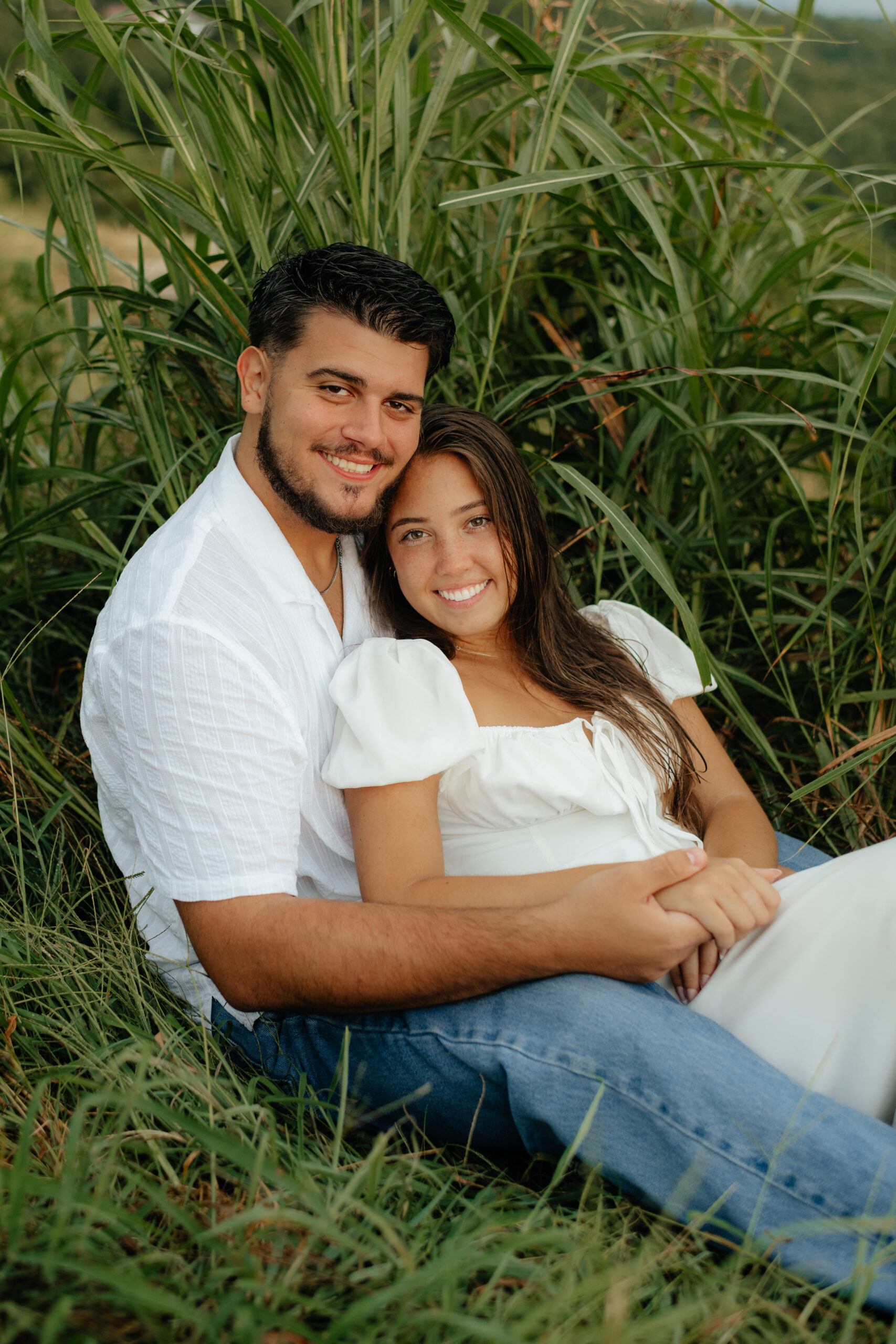 A couple snuggle at their Engagement Photos, Weathington Park, Guntersville, Alabama. Photos produced and edited by Alabama and Washington Wedding Photographer Sarah Mismash
