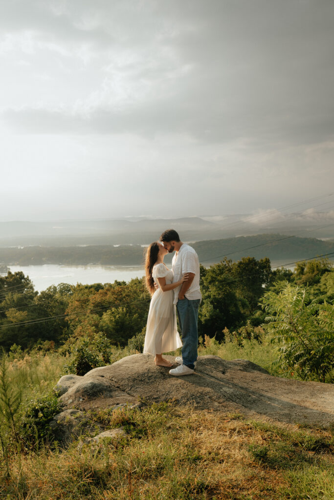 A couple weather the storm and kiss dramatically at their Engagement Photos, Weathington Park, Guntersville, Alabama. Photos produced and edited by Alabama and Washington Wedding Photographer Sarah Mismash