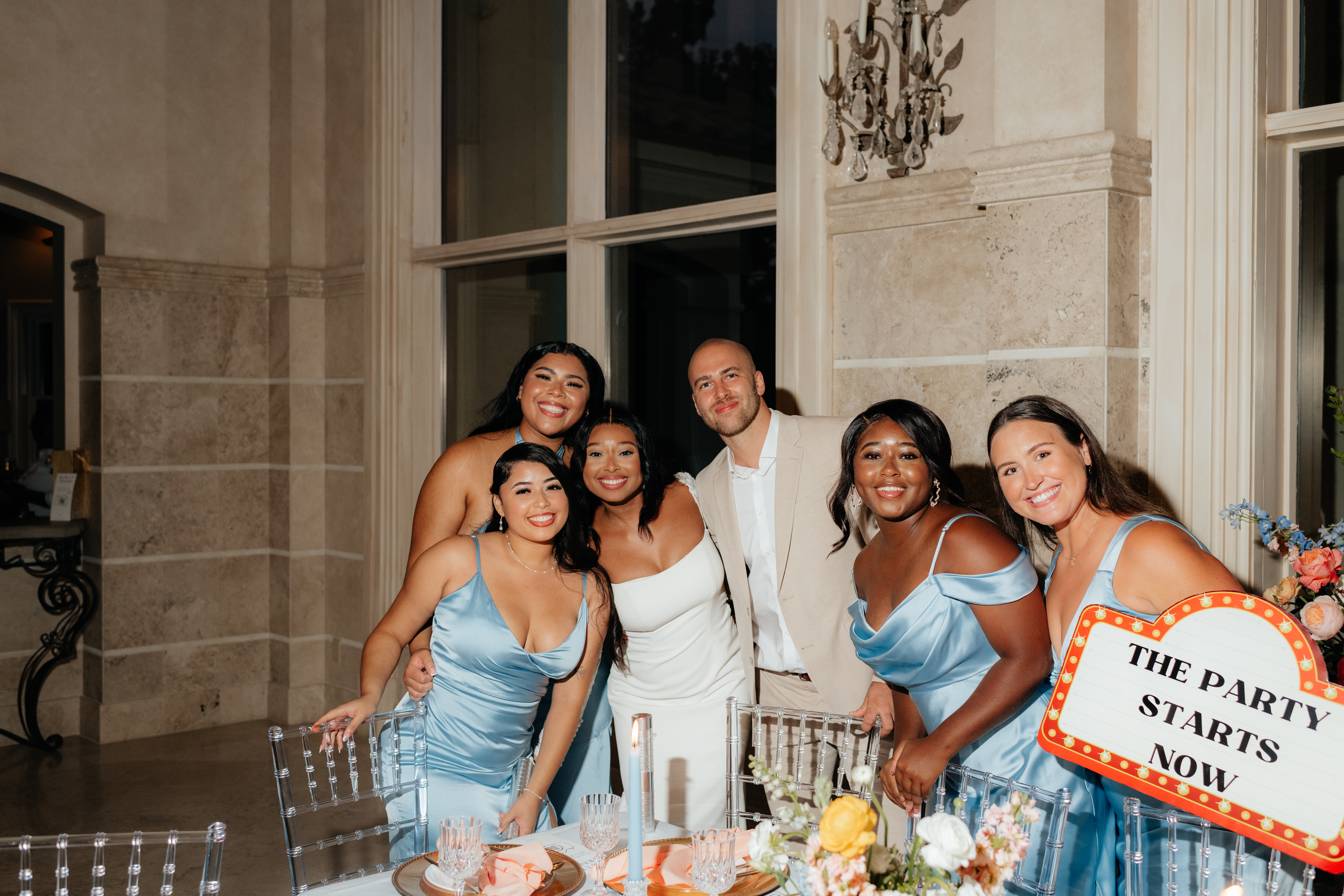 a couple and the bride's sisters smile for alabama wedding photographer Sarah Mismash during a summer wedding reception at lake Martin near Alexander city