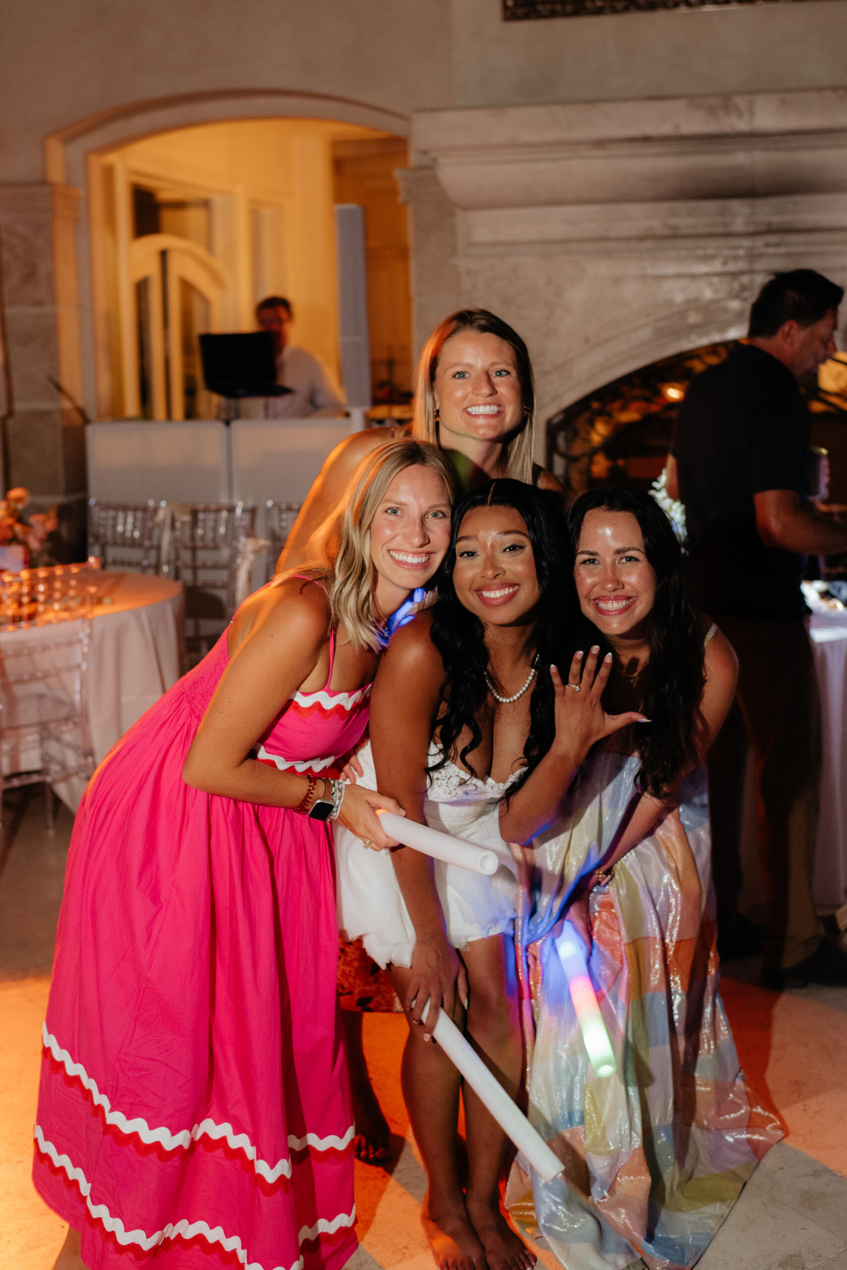 a bride poses with her friends on the dance floor during her wedding reception at lake Martin, near Alexander city alabama
