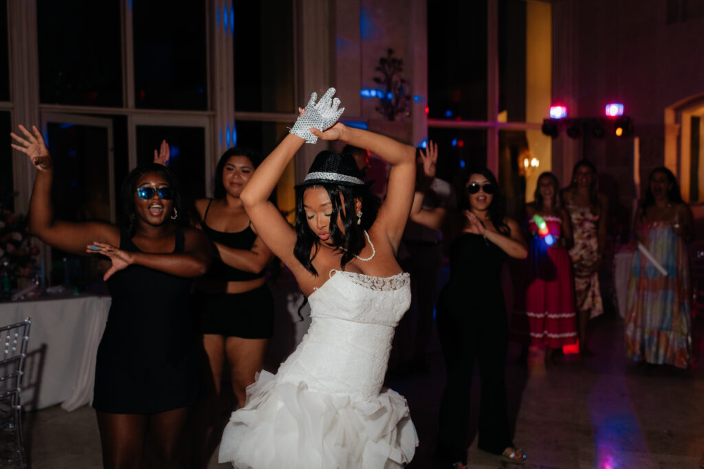 a bride dances with her sisters to thriller on the dance floor during her wedding reception at lake Martin, near Alexander city alabama