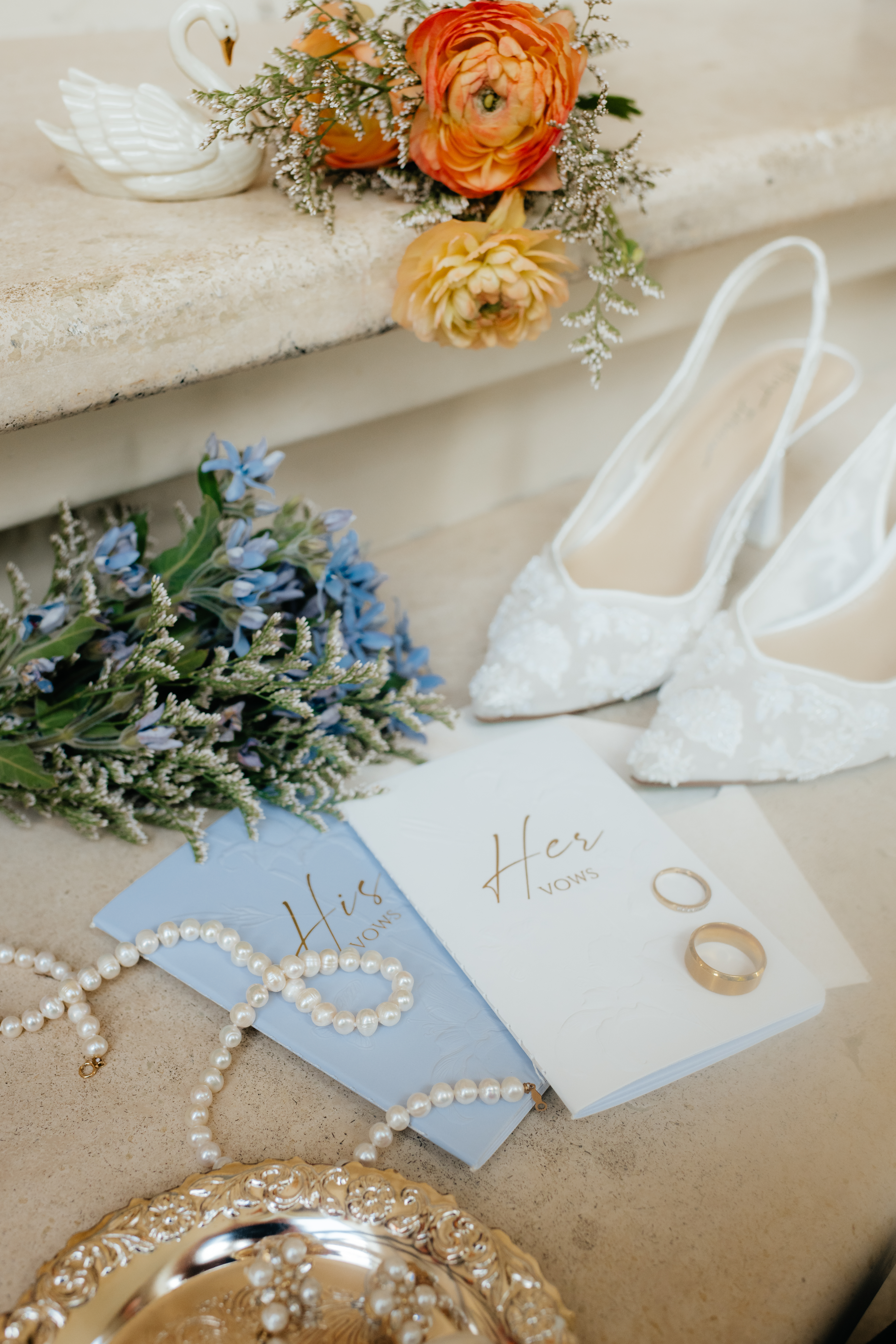 wedding ceremony florals and details including invitations and rings from a summer wedding at lake Martin by alabama wedding photographer Sarah Mismash