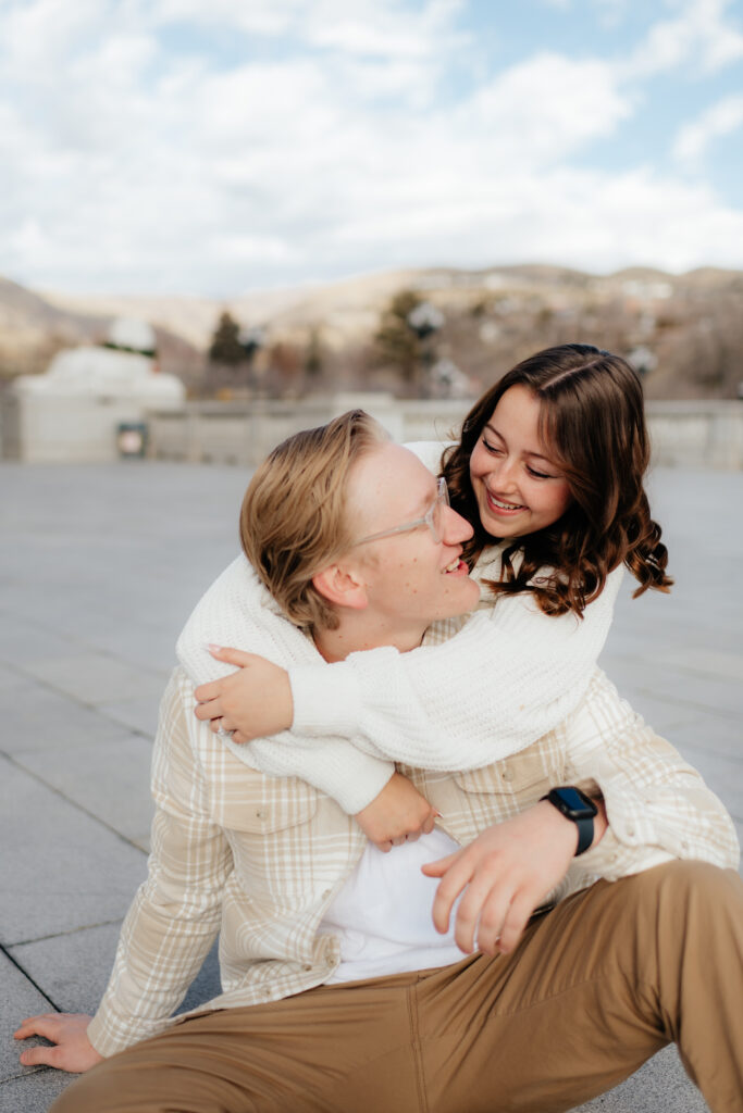 a couple hugs during their engagement photos at the state capital with olympia engagement photographer sarah mismash