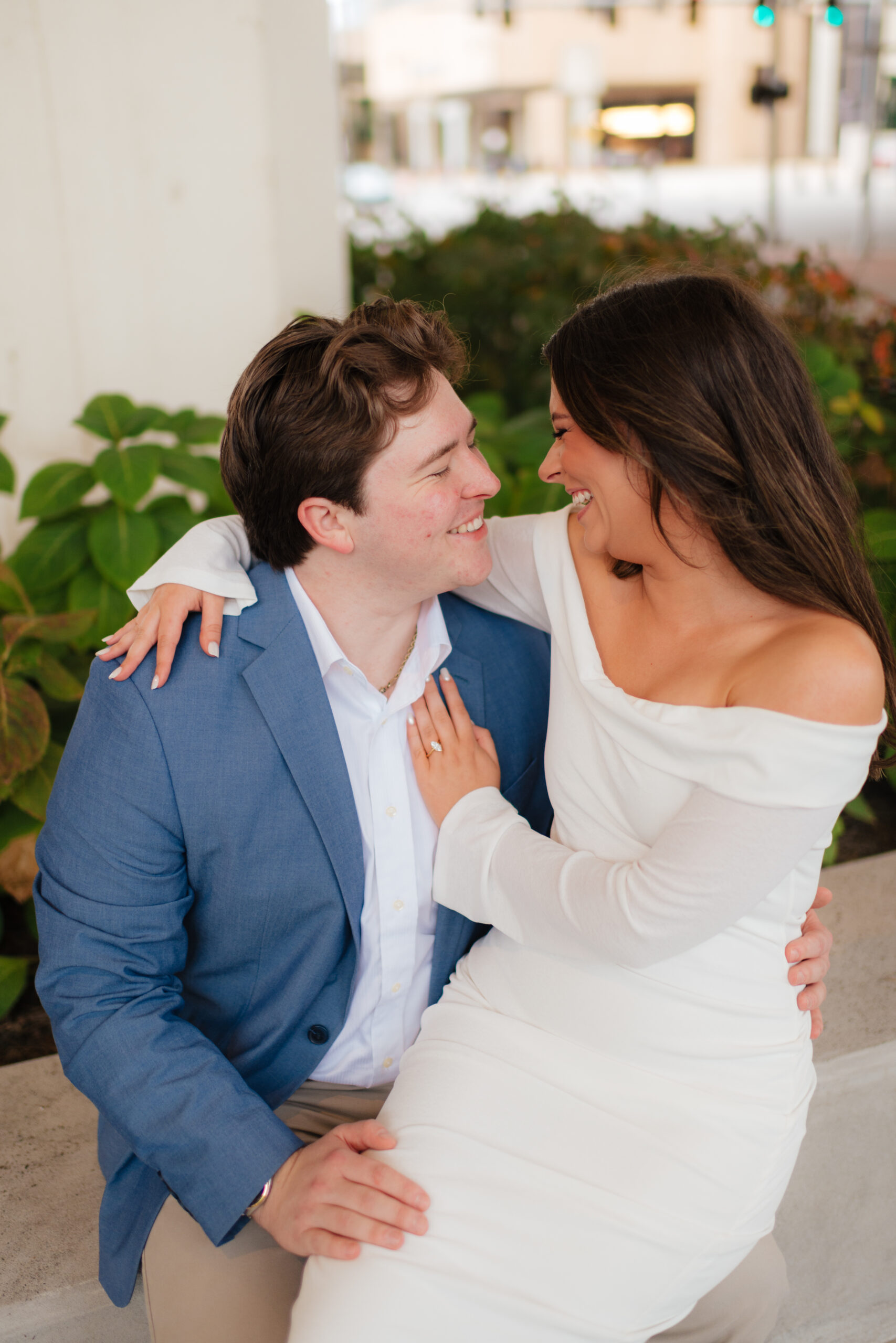 a couple sits together under the overpass at the Birmingham city walk near the bham museum of art during their downtown engagement photos with alabama wedding photographer Sarah Mismash