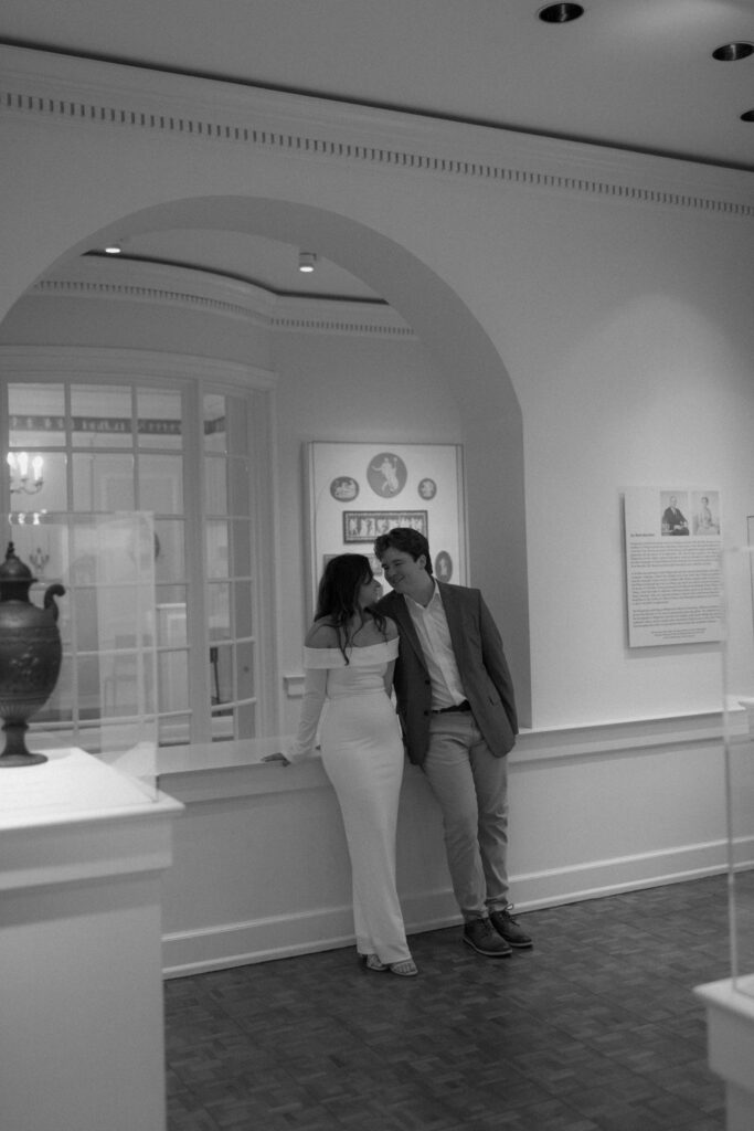 a couple smiles at each other during their engagement photos with alabama wedding photographer Sarah Mismash photography at the Birmingham museum of art in downtown bham