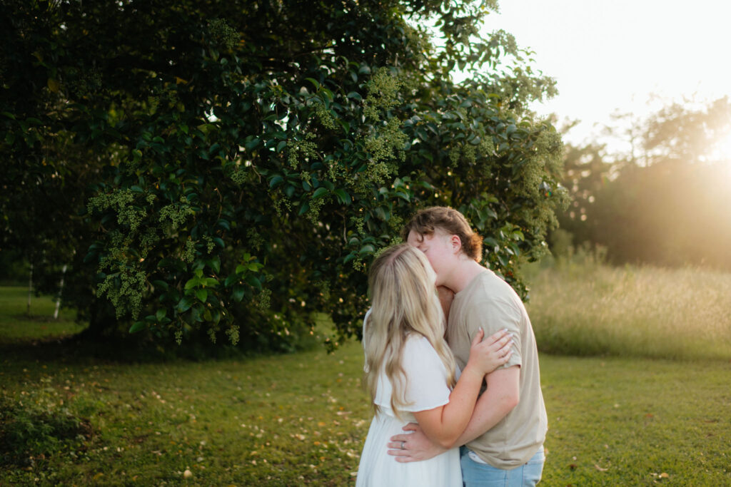 a couple kisses during their seattle orchard engagement photos with washington engagement photographer sarah mismash