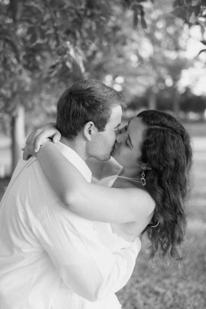 a couple kisses during their engagement photos at Guntersville Lake with central alabama wedding photographer Sarah Mismash