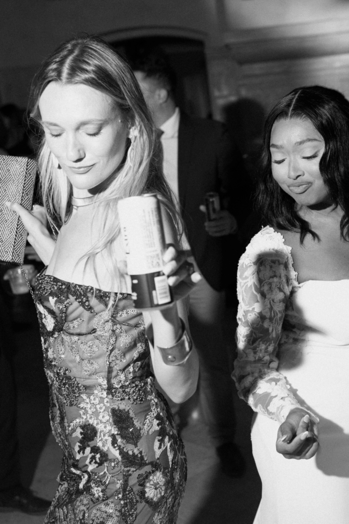 flash wedding dance floor photo of a bride and bridesmaid at a wedding in seattle, WA photographed by washington wedding photographer Sarah Mismash