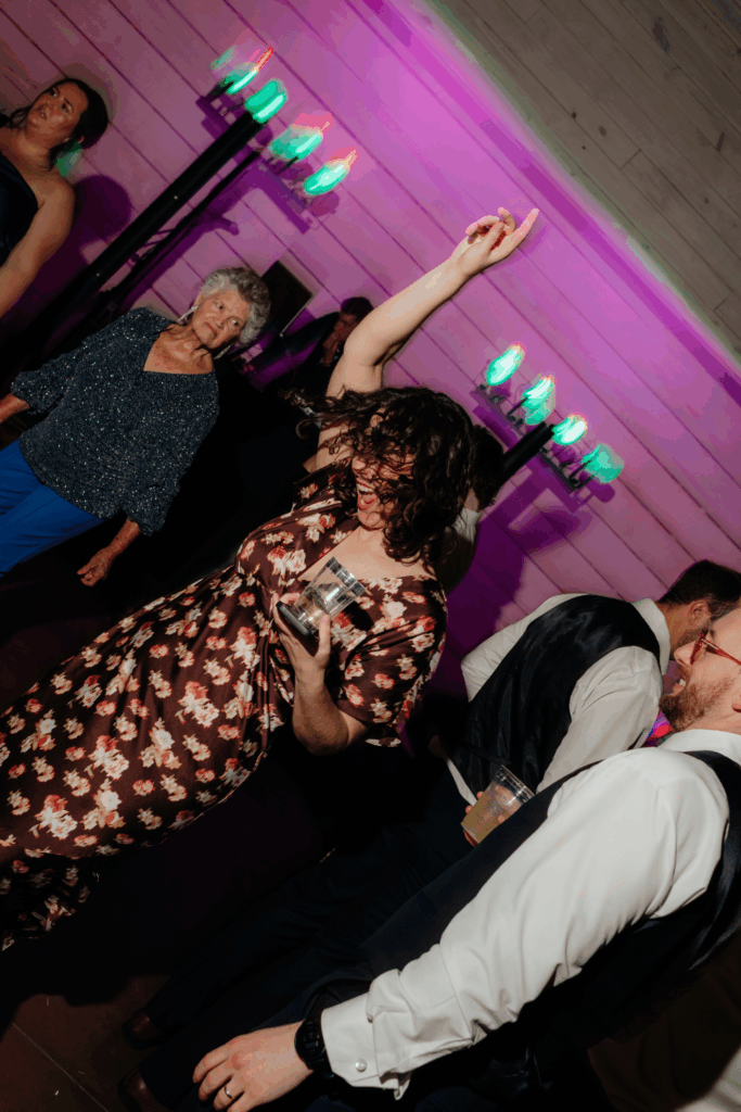 flash wedding dance floor photo of a bridesmaid dancing at a wedding in seattle, WA photographed by washington wedding photographer Sarah Mismash