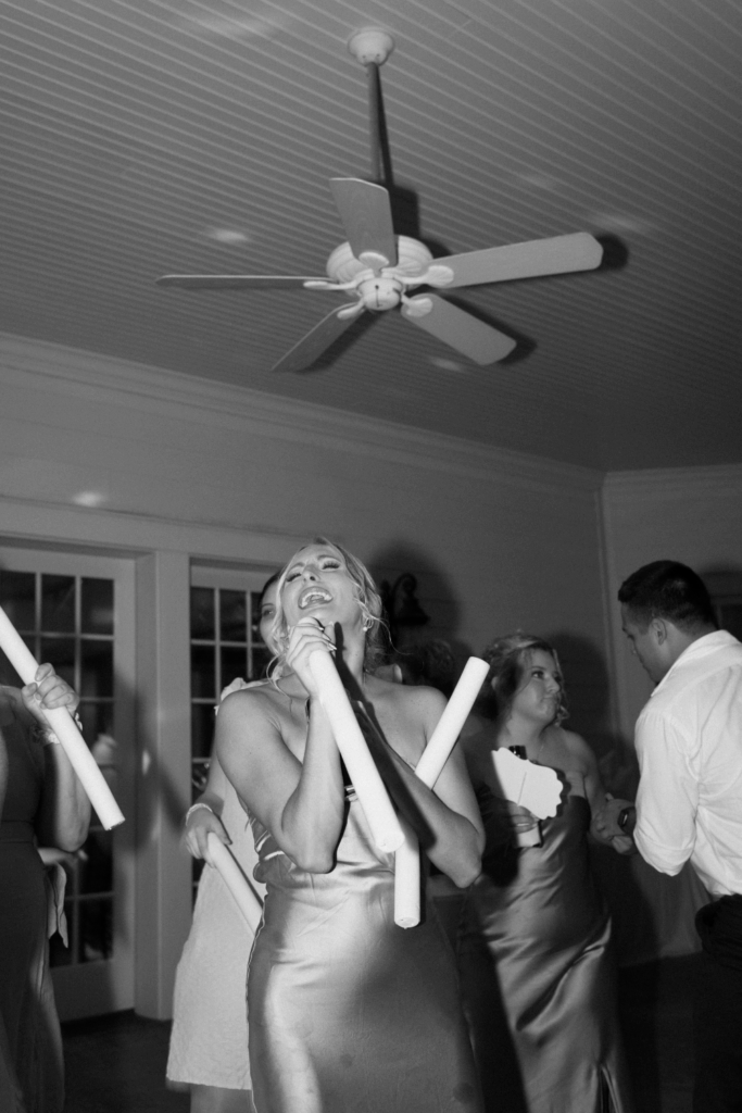 flash wedding dance floor photo of a bridesmaid dancing at a wedding in seattle, WA photographed by washington wedding photographer Sarah Mismash