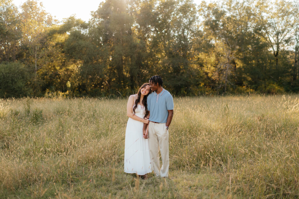a couple holds hands in a field during their engagement photos with Olympia, washington engagement photographer Sarah Mismash