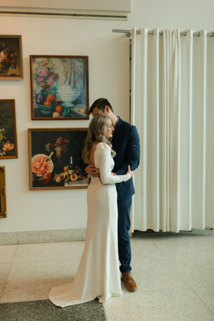 an engaged couple looks at paintings together during their engagement photos at the Seattle Art Museum with seattle engagement photographer Sarah Mismash