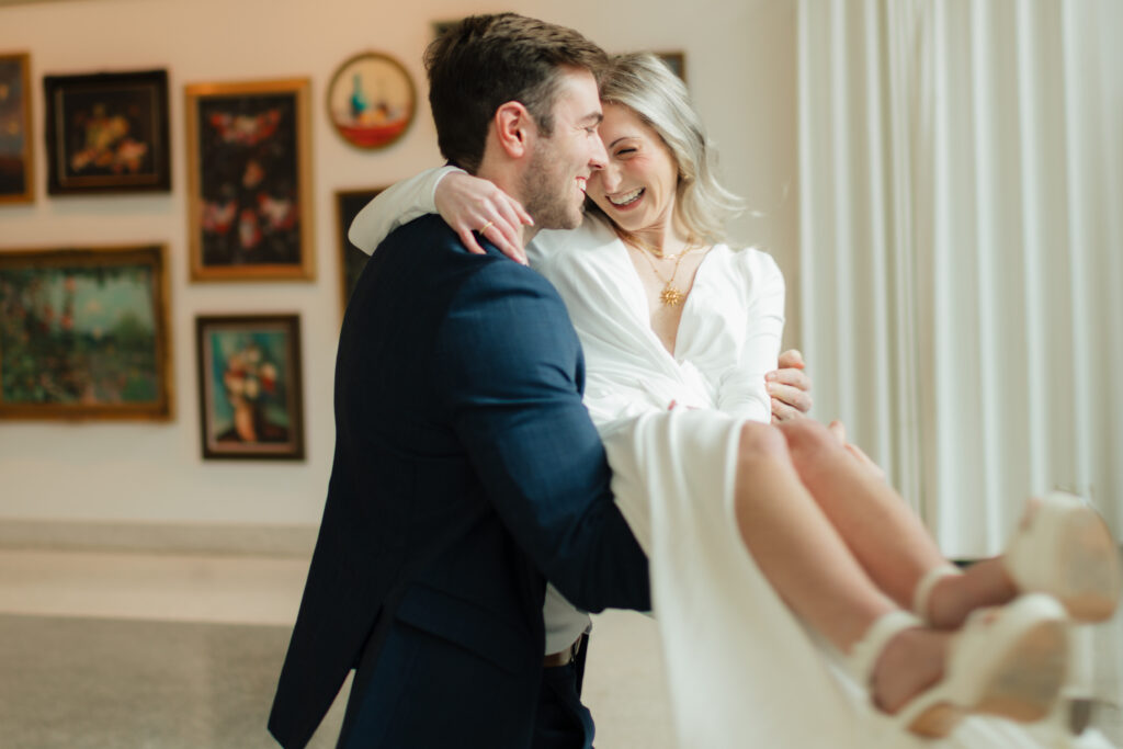a couple spins together during their engagement photos at the Seattle Art Museum with seattle engagement photographer Sarah Mismash 