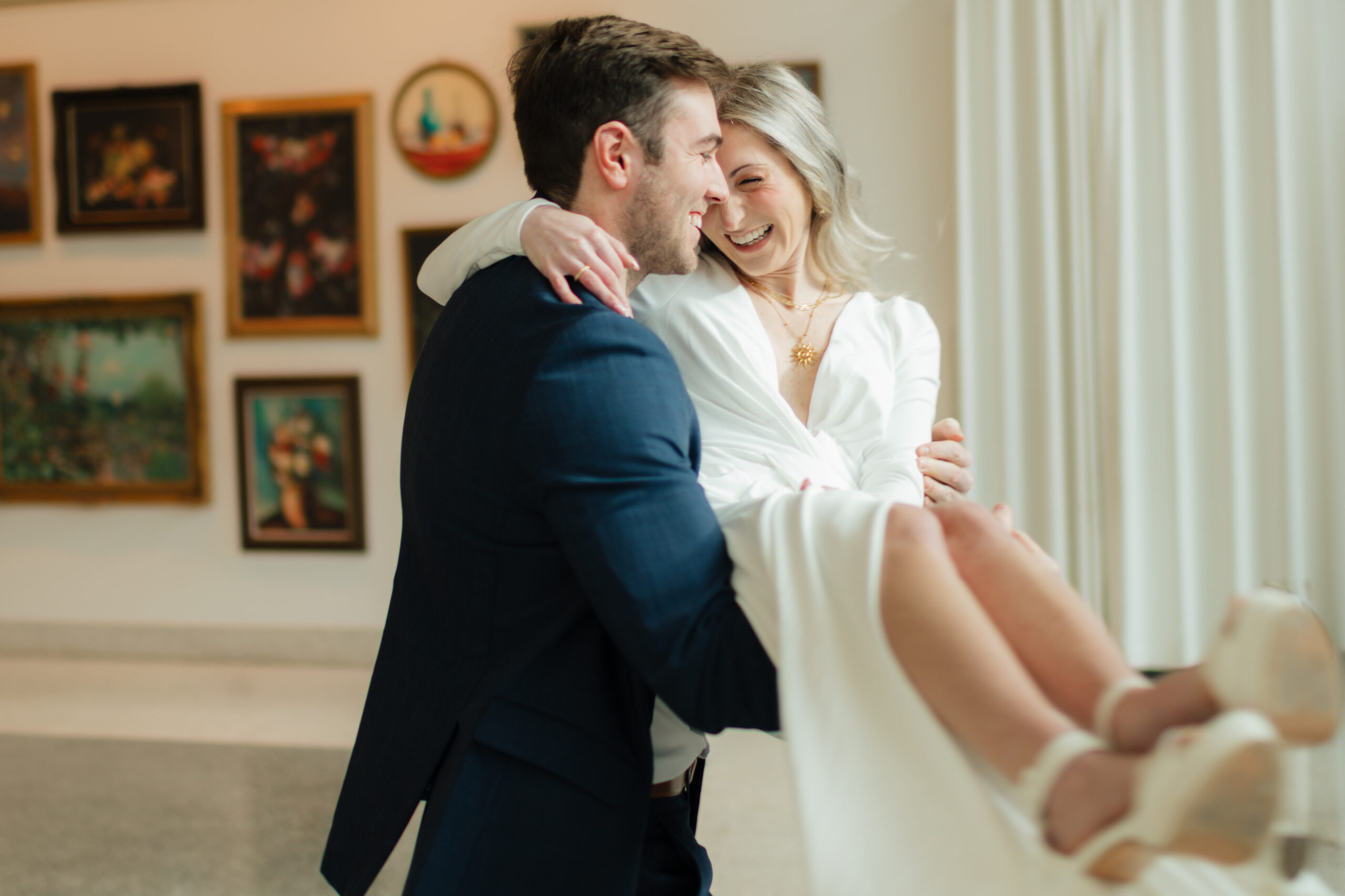 a couple spins together during their engagement photos at the Seattle Art Museum with seattle engagement photographer Sarah Mismash