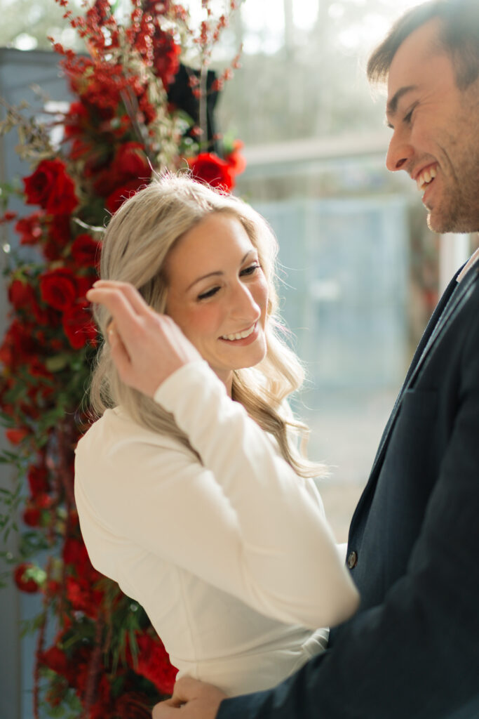 an engaged couple laughs together together during their engagement photos at the Seattle Art Museum with seattle engagement photographer Sarah Mismash