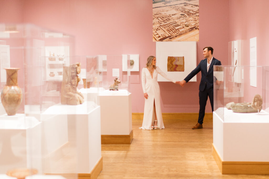 a couple stands together during their engagement photos at the Seattle Art Museum with seattle engagement photographer Sarah Mismash