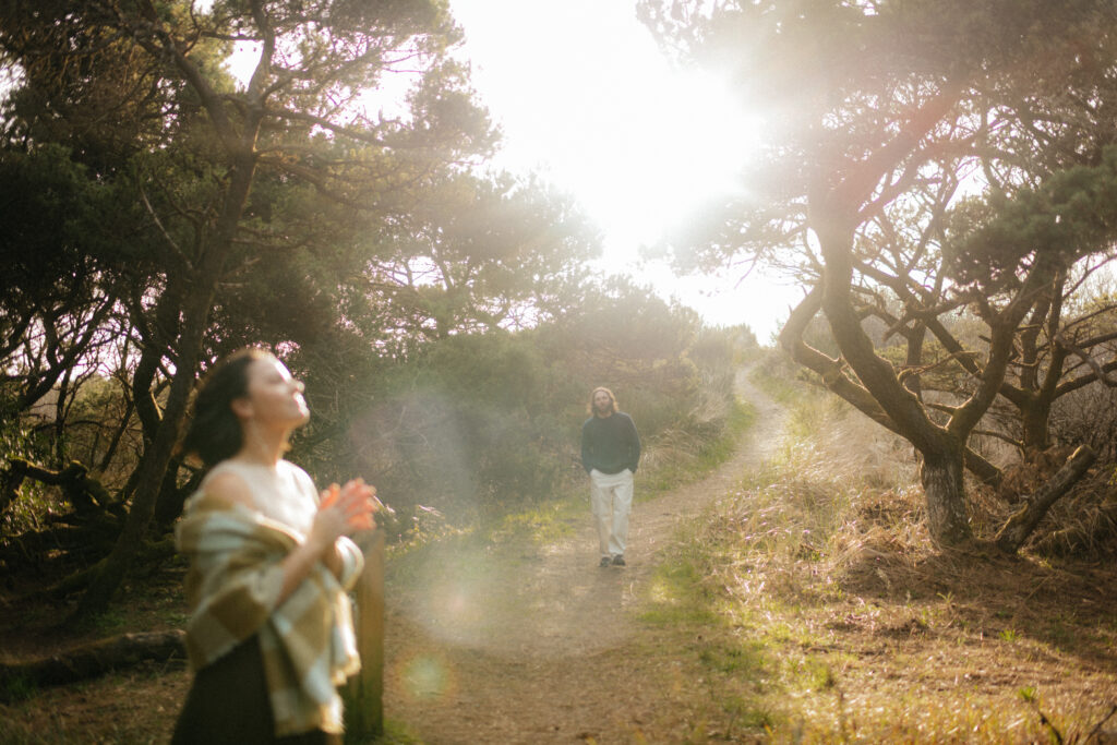 a couple sees each other during their engagement photos near the dunes at Westport Beach