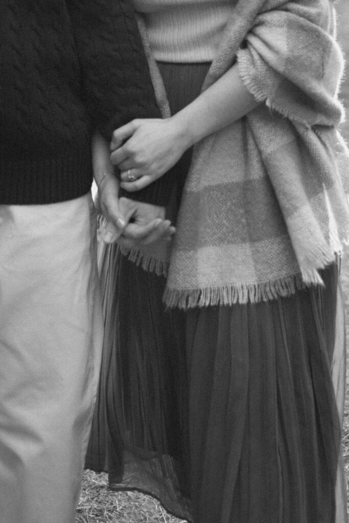 a couple holds hands during their washington coast engagement photos