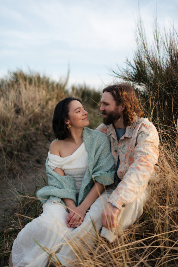 a couple looks at each other for a natural, relaxed and candid portrait during their engagement photos with washington state wedding photographer sarah mismash