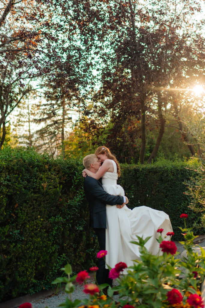 a couple spins during their bridal wedding portraits at thanksgiving point, in the ashton gardens in lehi utah with utah wedding photographer sarah mismash