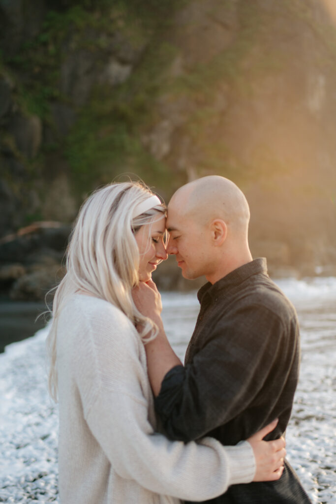 a couple during their summer engagement photos on the washington coast