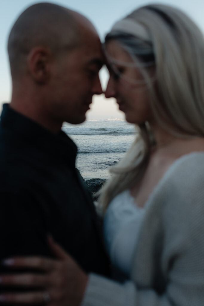 a couple during their summer engagement photos on the washington coast