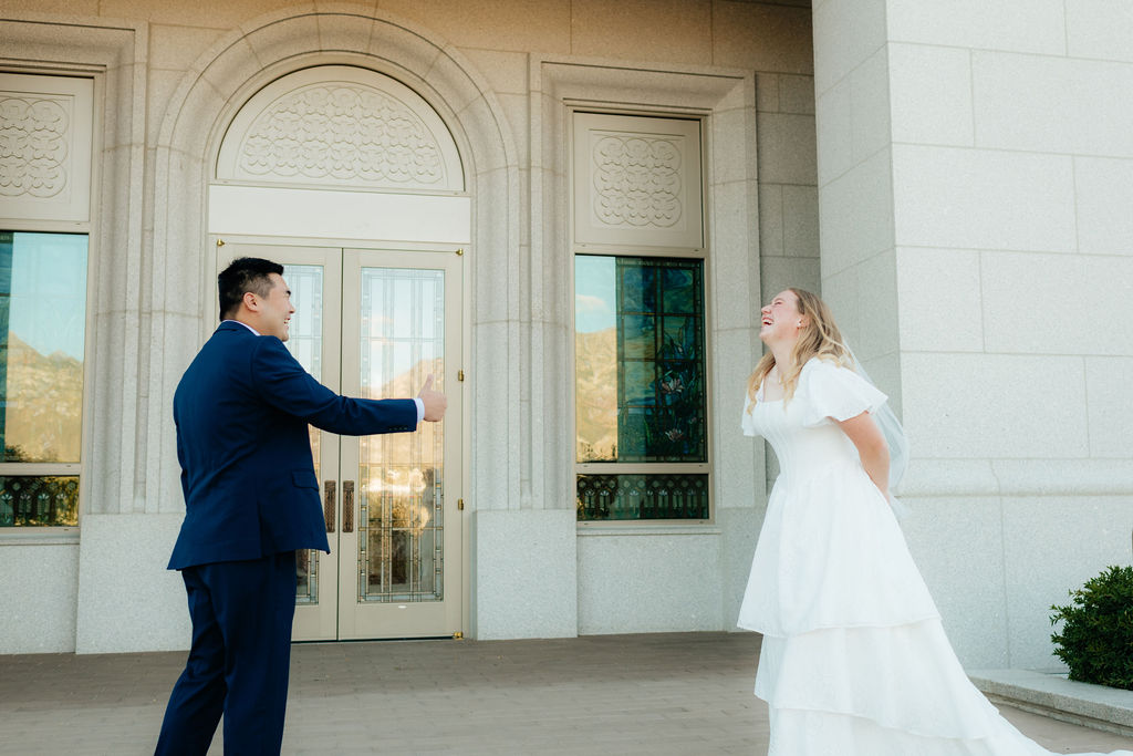 a couple laughs during their outdoor first look at the orem utah temple
