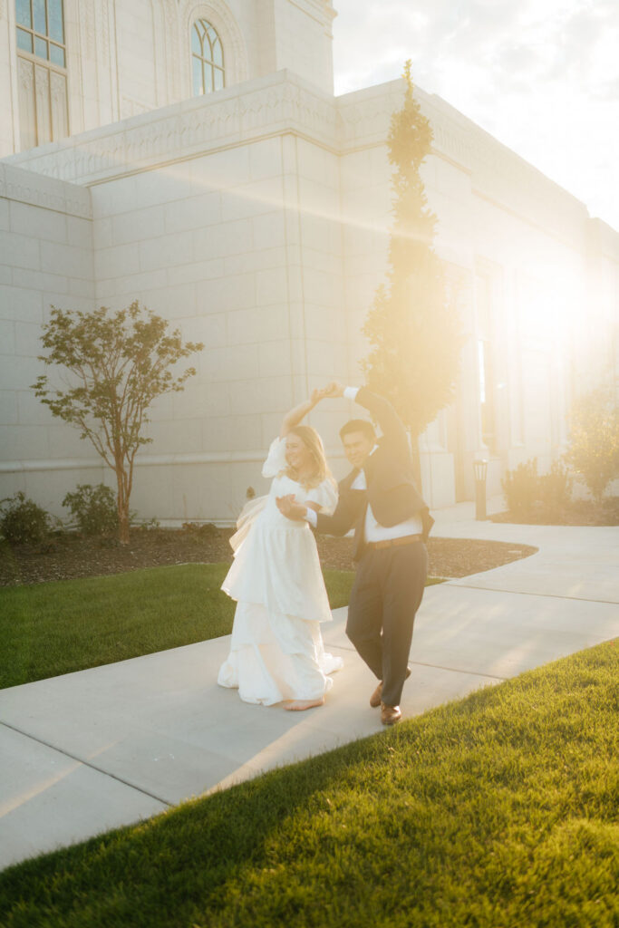 a couple dances during their bridal portraits at the orem temple in september