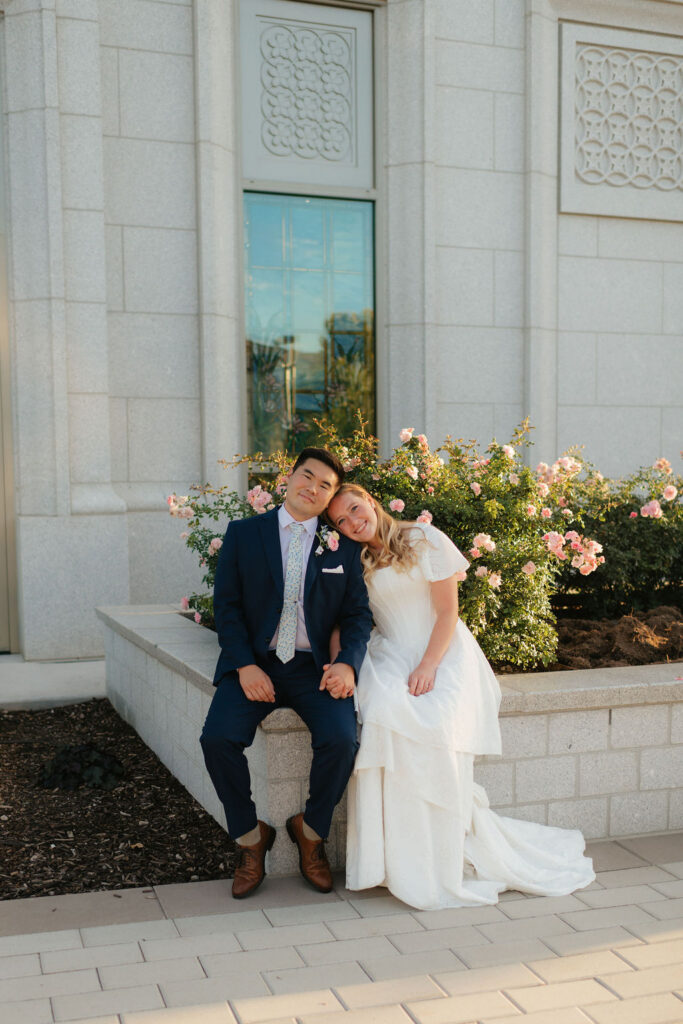 a couple smiles together for a traditional wedding portrait during their bridal photos at the orem temple