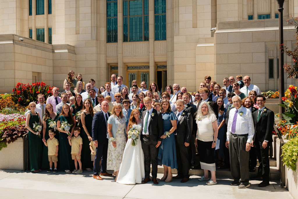 a large extended family photo on the steps during an august wedding photgraphed on the ogden temple grounds by utah wedding photographer sarah mismash
