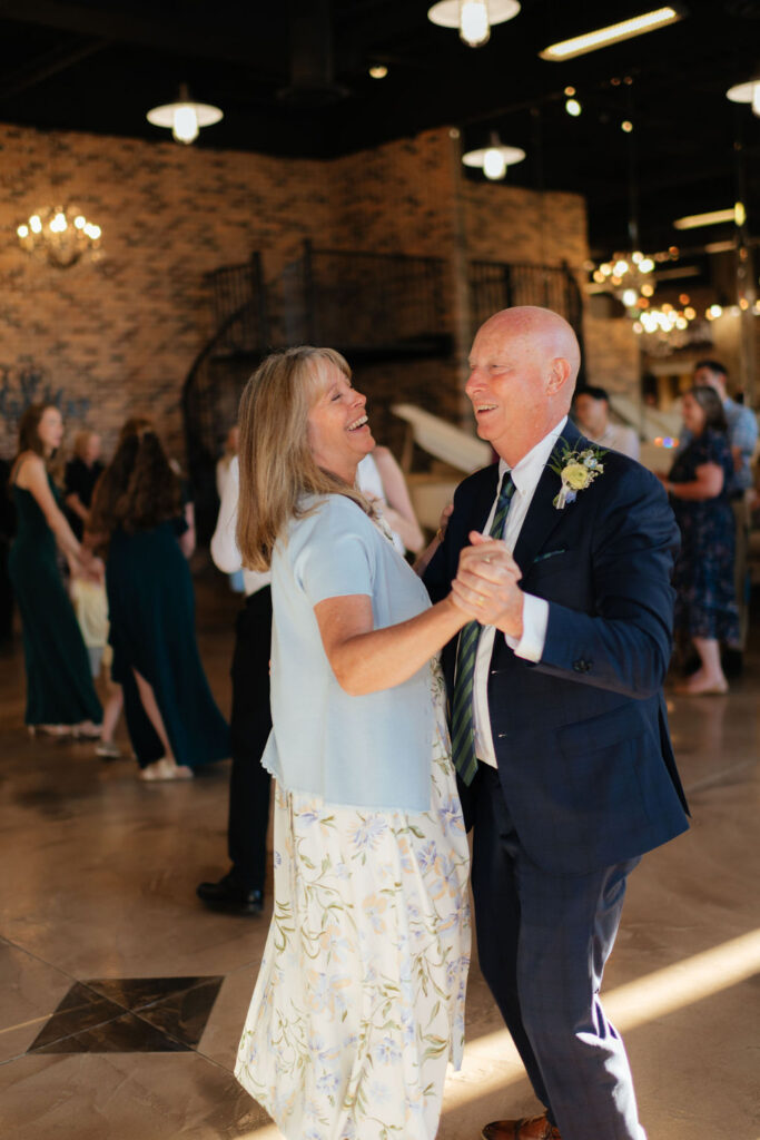 parents of the bride dance during an august wedding photgraphed at the grand view wedding venue in ogden, utah by utah wedding photographer sarah mismash