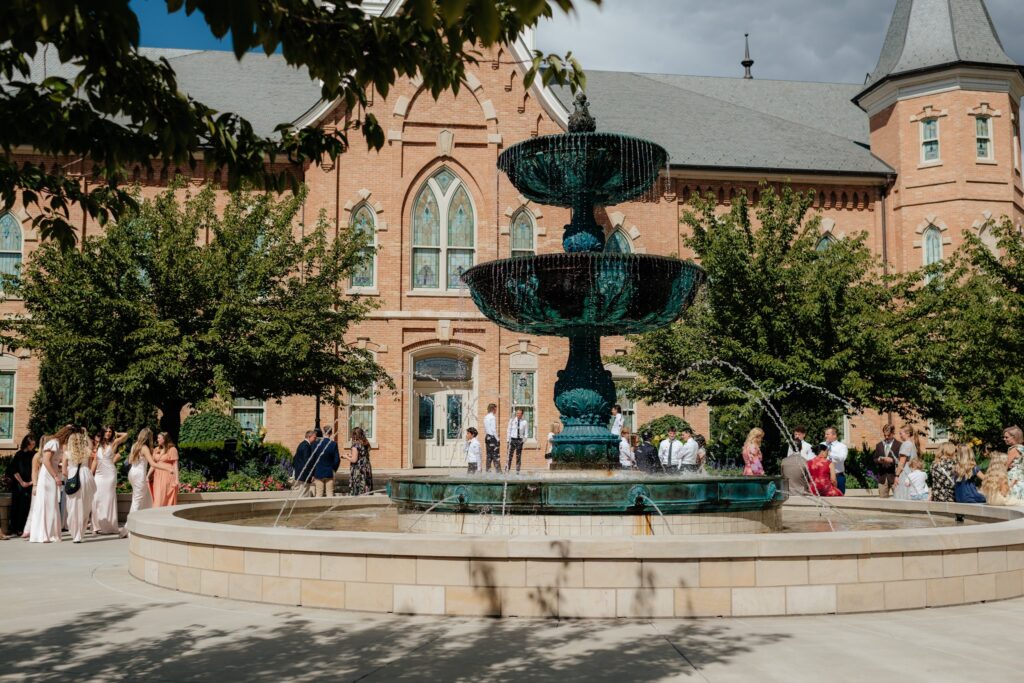 Wedding guests gather near the fountain on the Provo City Center Temple grounds during a September wedding.