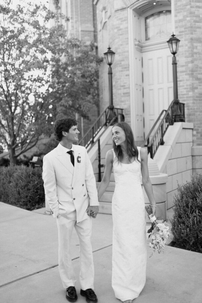 Black and White Portrait of Newlyweds Walking, Provo City Center Temple on a september afternoon