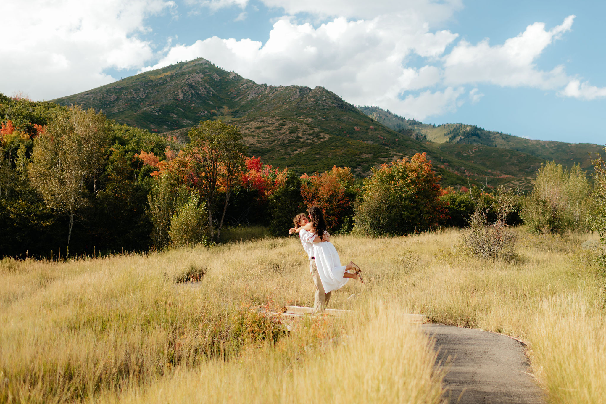 a couple spins during their fall engagement photos at cascade springs in american fork canyon, utah, with engagement photographer sarah mismash