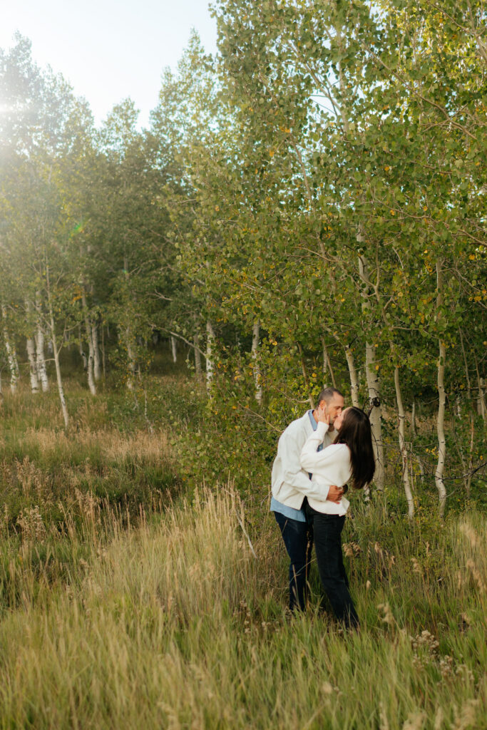 a couple kisses during their engagement photos on the alpine loop