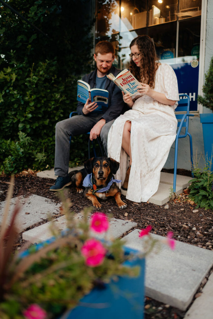 a couple reads together outside of the kings english bookstore in slc during their engagement photos
