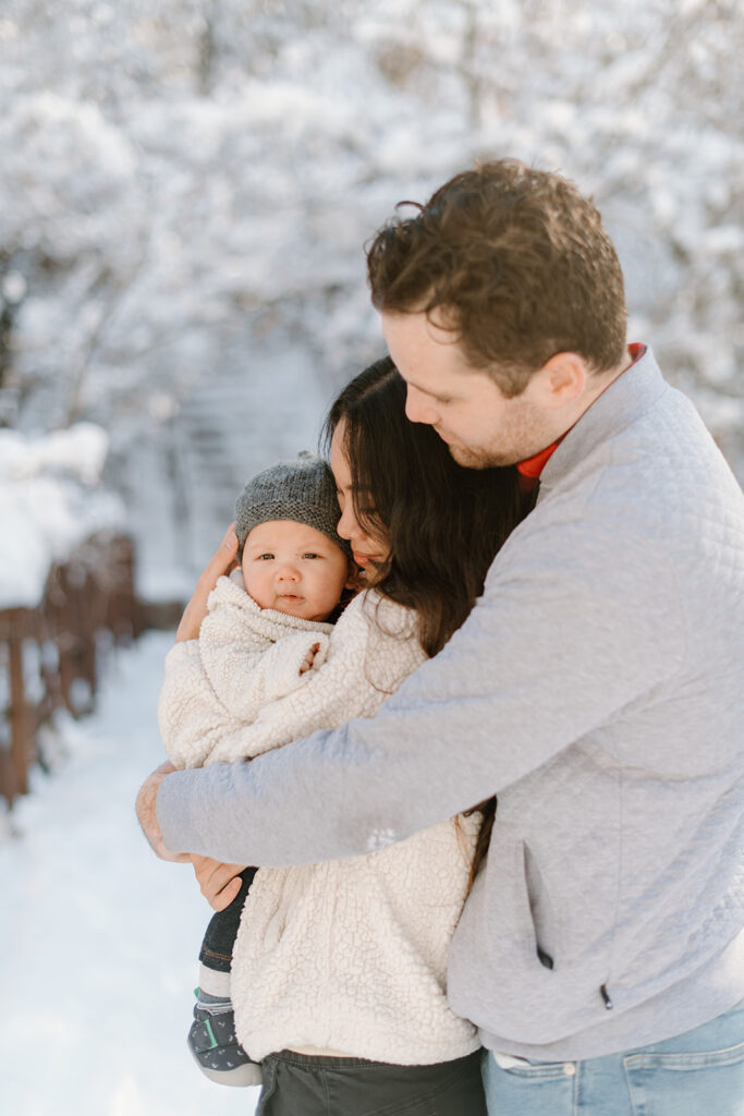a couple snuggles together during a snowy winter bridal session in utah county